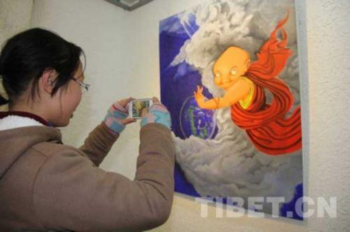 一位观众用手机拍摄自己喜欢的画作。 摄影：马静