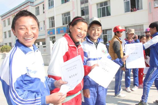 图为该县中学学生正在手持健康档案等待工作人员体检.jpg